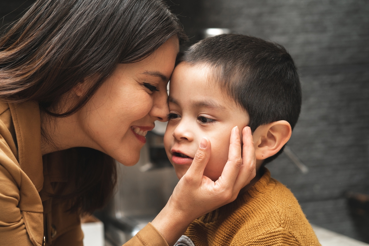 Mother kissing her child with autism.