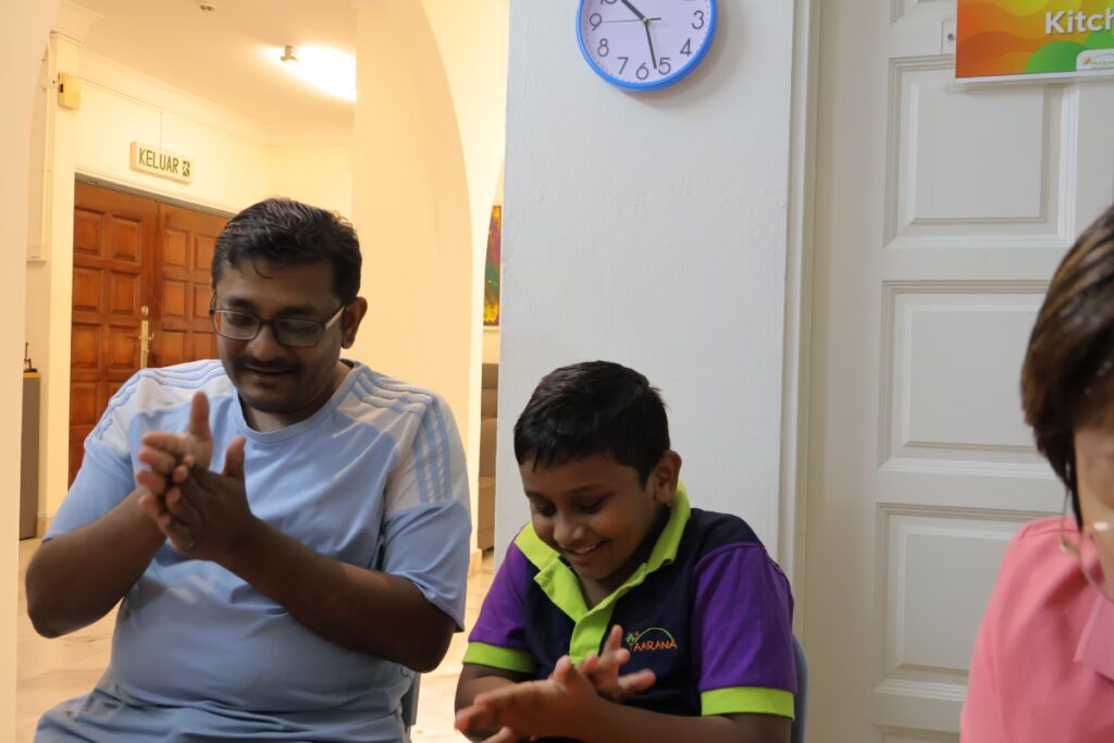 A kid is smiling with his dad