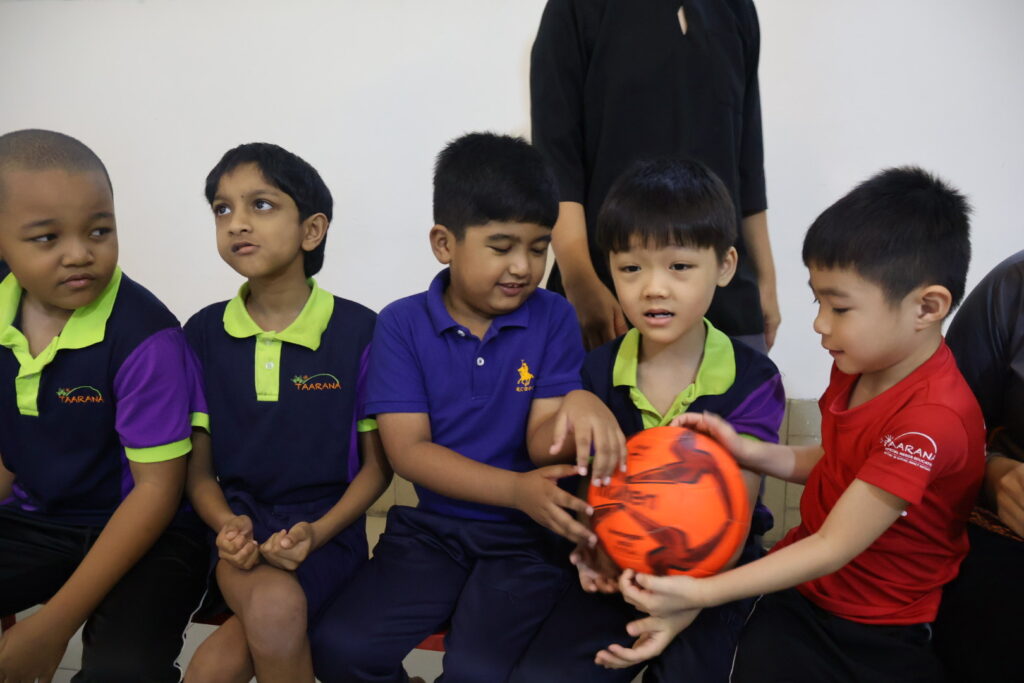 Taarana kids pass a ball