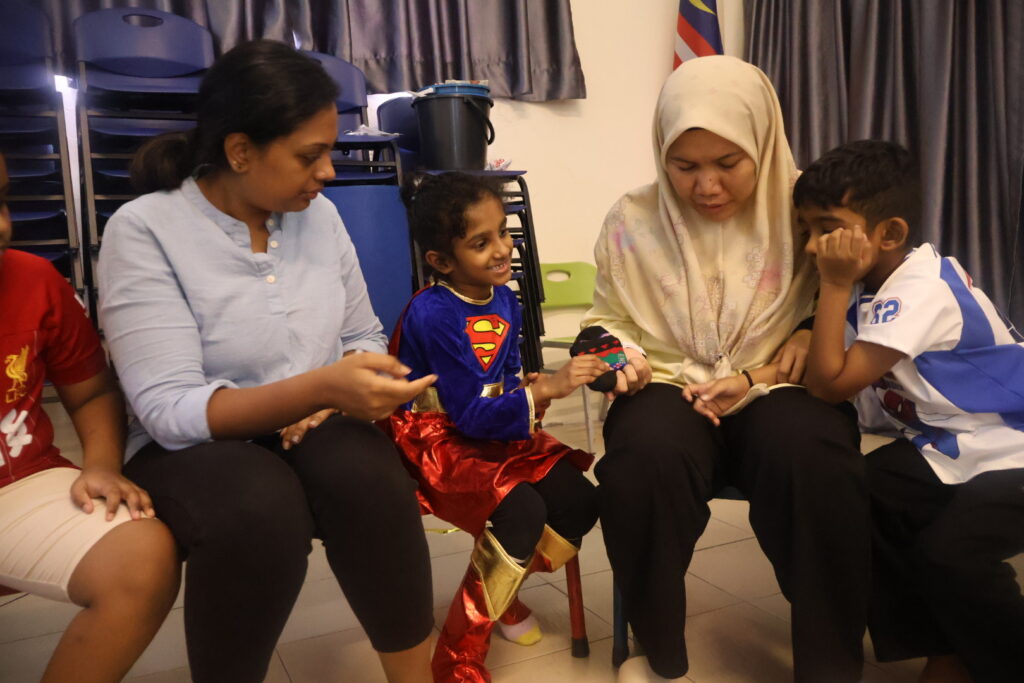 student and teachers together passing the socks